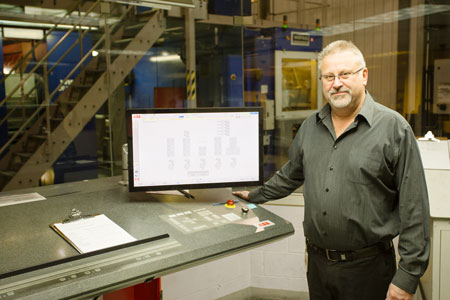 Mike Murtha, Director, Production and Facilities, at the Halifax Herald, with one of the ABB control consoles